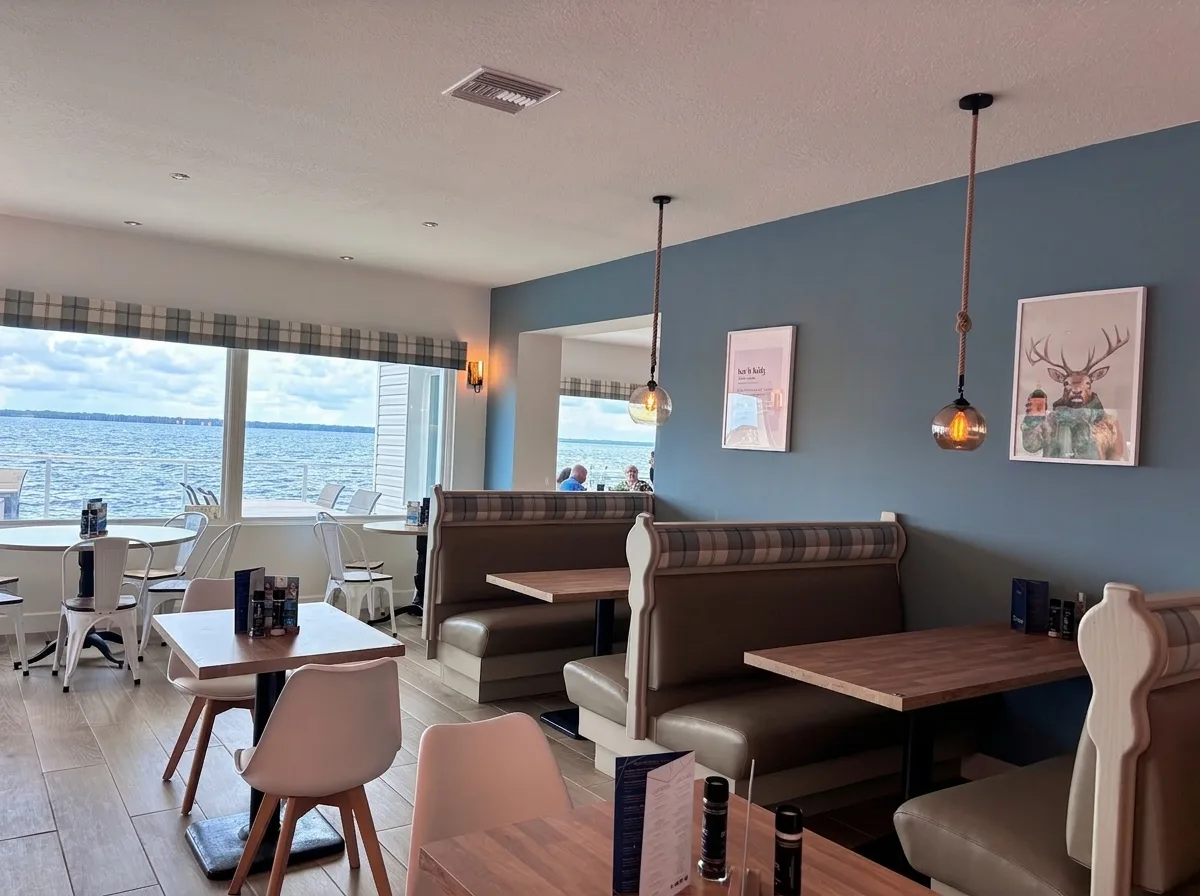 The Lochside Restaurant dining room in Crescent City, FL, with tartan booths and windows overlooking Crescent Lake